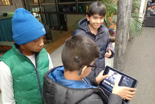 Drei Jungen filmen mit einem iPad
